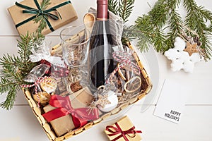 Refined Christmas gift basket for culinary enthusiats with bottle of wine and mulled wine ingredients