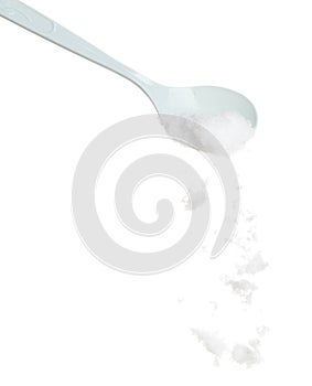 Refined Salt fall down pouring in plastic spoon, powder white salts explode abstract cloud fly. Small ground salt splash in air,