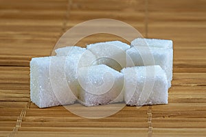 Refined sugar on bamboo background