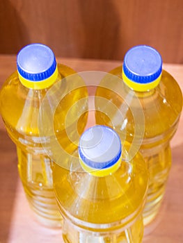 Refined Sunflower oil is light and odorless, poured into plastic bottles with a blue lid. photo