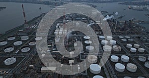 Refineries and the three steam crackers in the port of Antwerp, Belgium at dusk. Petrochemical silos and storage