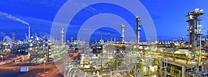 Refinery - chemical factory at night with buildings, pipelines and lighting - industrial plant