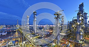 Refinery - chemical factory at night with buildings, pipelines and lighting - industrial plant