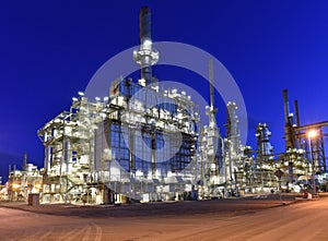 Refinery - chemical factory at night with buildings, pipelines and lighting - industrial plant