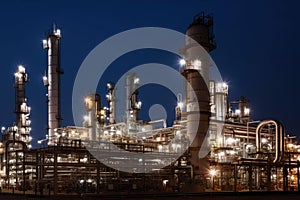 refinery with countless pipes, tanks, and valves to distill and process oil