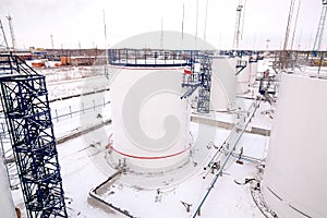 Refinery factory oil storage tanks under cloudy sky