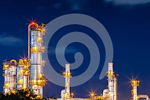 Refinery oil and gas industry at night blue sky after sunset time with chemical and petroleum for energy of transportation and