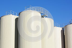 Refinery oil storage tanks and blue sky