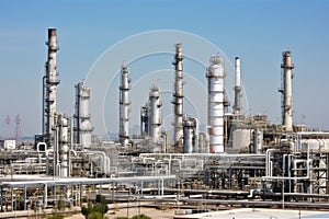 refinery, with rows of tanks and pipes producing oil and other petrochemicals