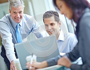 Refining our business strategy. A group of three businesspeople having a meeting while sitting around a conference table