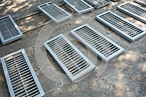 Refinished old metal drainer  with grey color spray on concrete floor