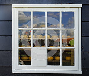 Reflaction of Zaanse Schans Windmills in window