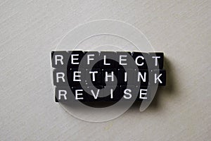 Reflect - Rethink - Revise on wooden blocks. Business and inspiration concept