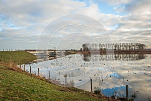 Reflected bridge in a flooded Dutch polder