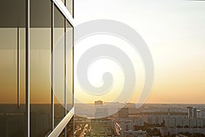 Reflected in the glass of an office building at sunset