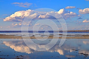 Reflecting clouds over the mirror surface of a salty shallow estuary