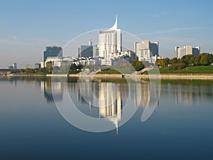 Reflecting Donaustadt skyline with tall apartment buildings in Danube river, Vienna - Austria