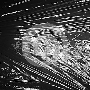 Reflecting light and shadow on creases and pleats in stretched black plastic sheeting