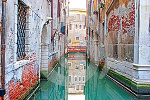 reflectio of old facades in a narrow canal in Venice photo