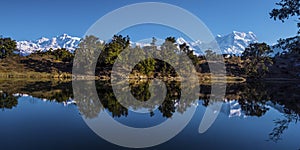 Reflection of 300 degree range of mountain and sky in the calm water of Deorital lake.nd.