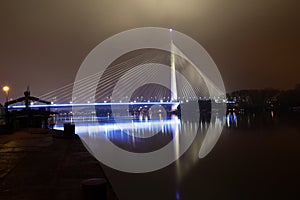 Reflection of Ada bridge and ship on Sava river