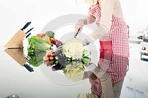 Reflection of Asian woman cooking food