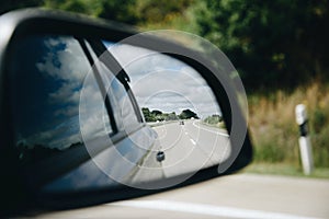 Reflection of highway at car side mirrow