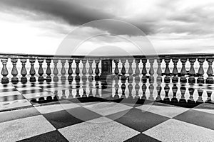 The reflection of the baluster in the rain puddles on the Terrazza in Livorno, Italy