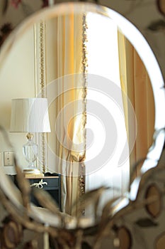 Reflection of a beautiful lamp in a mirror