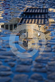 Reflection of the bell tower of Santillana del Mar Collegiate Church photo