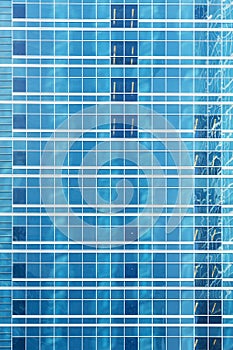 Reflection in blue glass wall of an modern office building