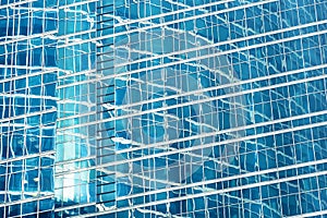 Reflection in blue glass wall of an modern office building