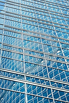 Reflection in blue glass wall of an modern office building