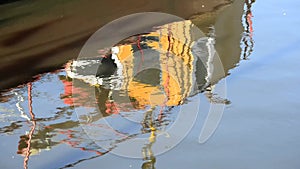 Reflection of a boat in the port