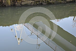 reflection of a bridge in a standing water channel