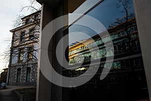 Reflection of a building on the front window of another modern building
