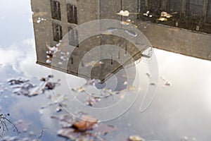 Reflection of a building in a puddle