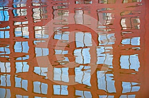 Reflection of the building windows in the relatively calm river