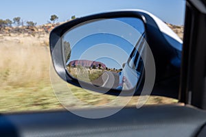 Reflection in a car mirror, Driving in a car on the road 4 through Yulara, Ayers Rock, Red Center, Australia