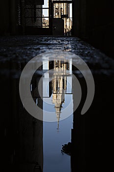 Reflection of the cathedral of Toledo in a puddle