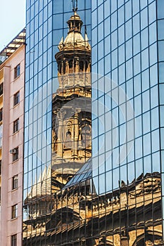 Reflection of church tower on an office building photo