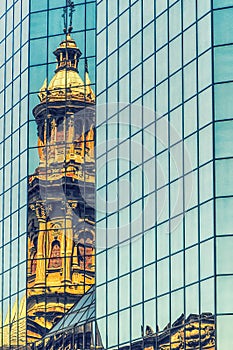 Reflection of church tower on an office building photo
