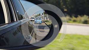 Reflection of city road in side rear view mirror, traffic rules, driving license