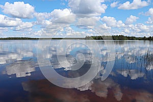 Reflection of clouds and blue Sky in Lake Ranuanjarvi in Finland