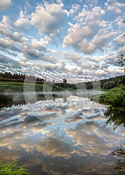 Reflection of clouds in the water on the Ugra river