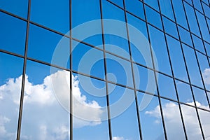 Reflection of a cloudy sky in glass wall