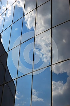 Reflection of a cloudy sky in glass wall