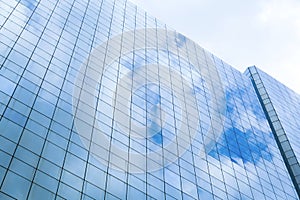 Reflection of a cloudy sky in glass wall