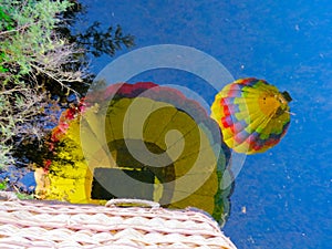 Reflection of a colorful Balloons flyng in the blue sky
