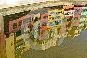 Reflection of colorful old houses the water of Onyar river in Girona, Spain